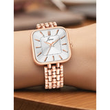 Silver dial women's watch styled on wrist with rose gold strap
