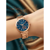 Blue dial rose gold ladies watch worn on wrist